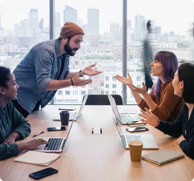 An image of an open office workers discussing something